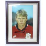 A framed signed photograph of Stuart Pearce in Forest colours