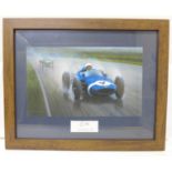 A framed artist's print of Stirling Moss with mounted autograph