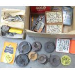 A collection of fishing reels, fishing flies, etc.