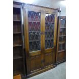 A carved oak linenfold four door bookcase