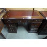 A mahogany and leather topped pedestal desk