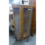 A walnut single door display cabinet