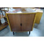 A walnut tambour bow front cabinet