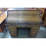 An early 20th Century oak tambour roll top desk, 114cms h, 122cms w, 69cms d