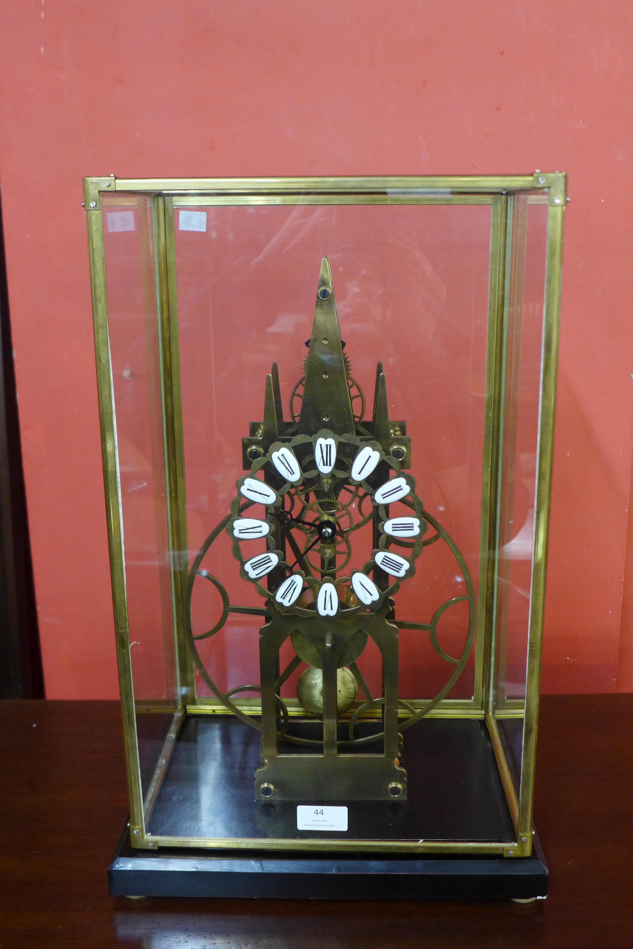 A cased brass skeleton clock, 54cms h
