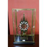 A cased brass skeleton clock, 54cms h