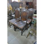 A set of four oak and leather upholstered dining chairs