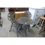 A cast iron garden table and two chairs