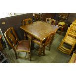 An oak draw-leaf table and four chairs