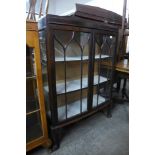 A mahogany two door bow front display cabinet
