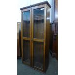 A Victorian oak two door gun cabinet, 131cms h, 63cms w, 24cms d