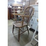 An elm and beech wheelback elbow chair