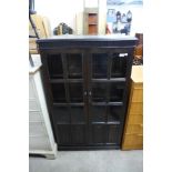 A carved oak linenfold two door bookcase