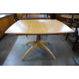 An Ercol Blonde ash Windsor extending dining table