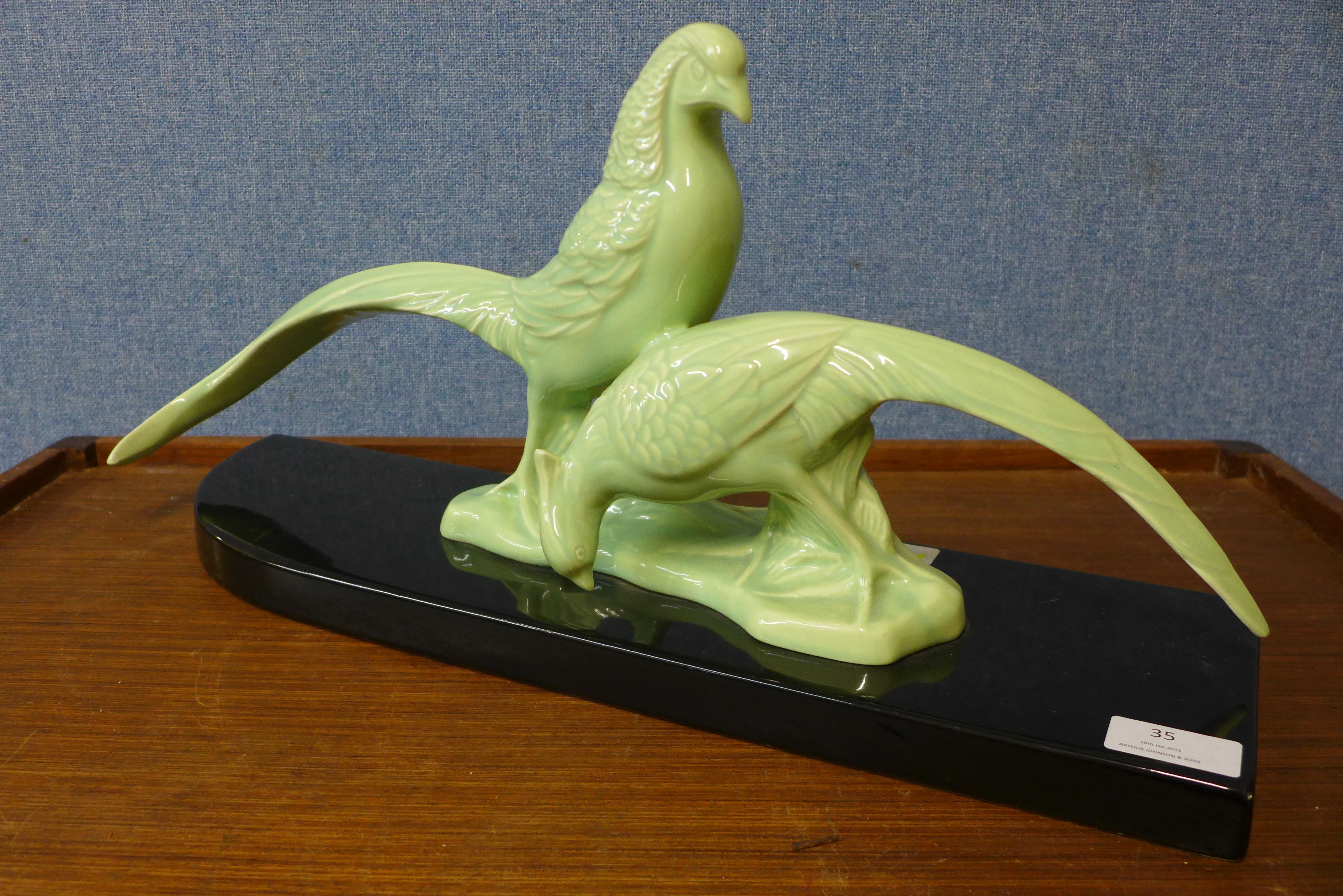 An Art Deco celadon coloured ceramic figure of two pheasants, 49cms l