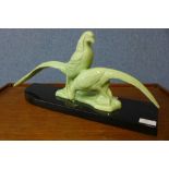 An Art Deco celadon coloured ceramic figure of two pheasants, 49cms l