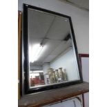 A black and silver effect framed mirror