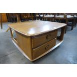 An Ercol Blonde elm Pandora's Box coffee table