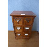 A hardwood table top six drawer index chest