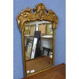 A rococo style gilt framed mirror, 69cms h