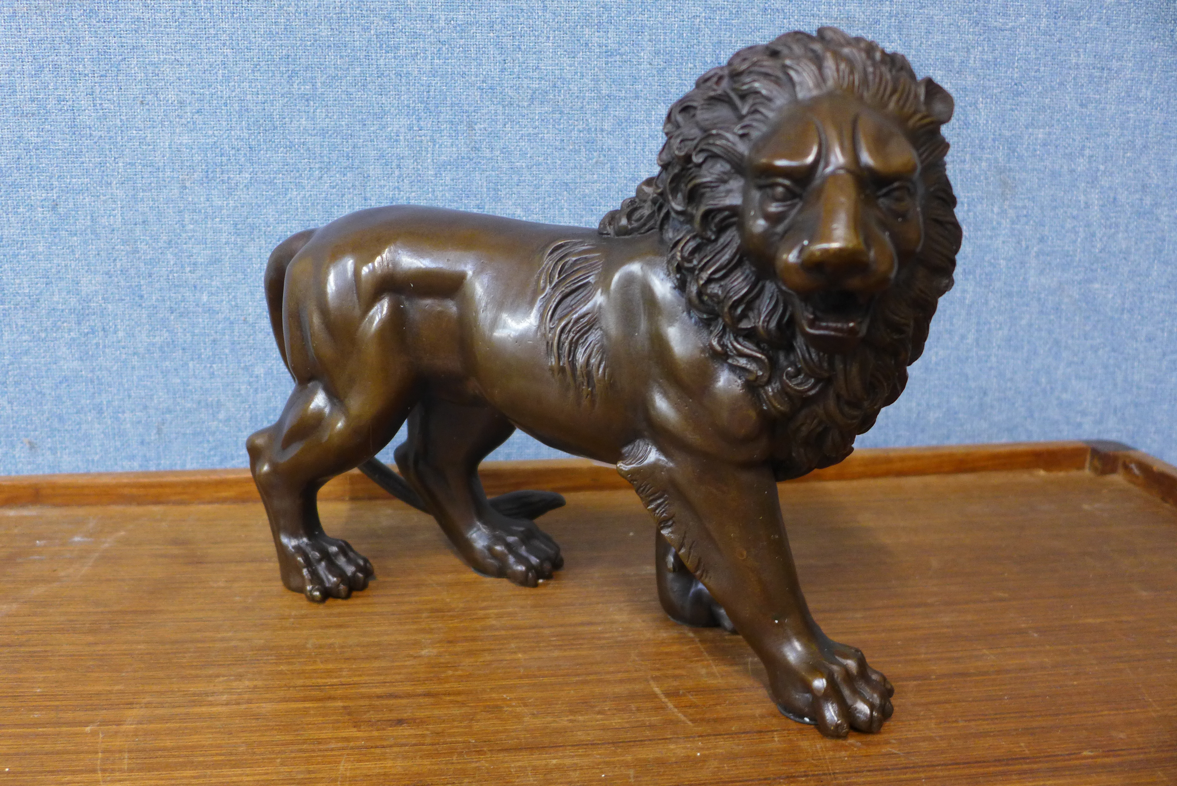 A bronze figure of a lion, 23cms h