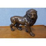 A bronze figure of a lion, 23cms h