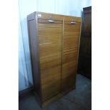 A mid 20th Century French light oak tambour front filing cabinet, 150cms h, 84cms w, 38cms d