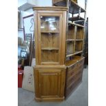 A pine freestanding corner cabinet