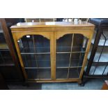 A walnut two door display cabinet