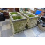 A set of four concrete garden planters