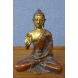 An oriental gilt bronze figure of a seated deity, 20cms h
