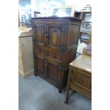 A 17th Century style carved oak cupboard