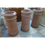 A set of three terracotta chimney pots