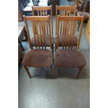 A set of four teak dining chairs