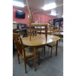 A teak extending dining table and four chairs