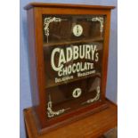 A mahogany counter top shop display cabinet, bearing Cadbury's Chocolate inscription to door,