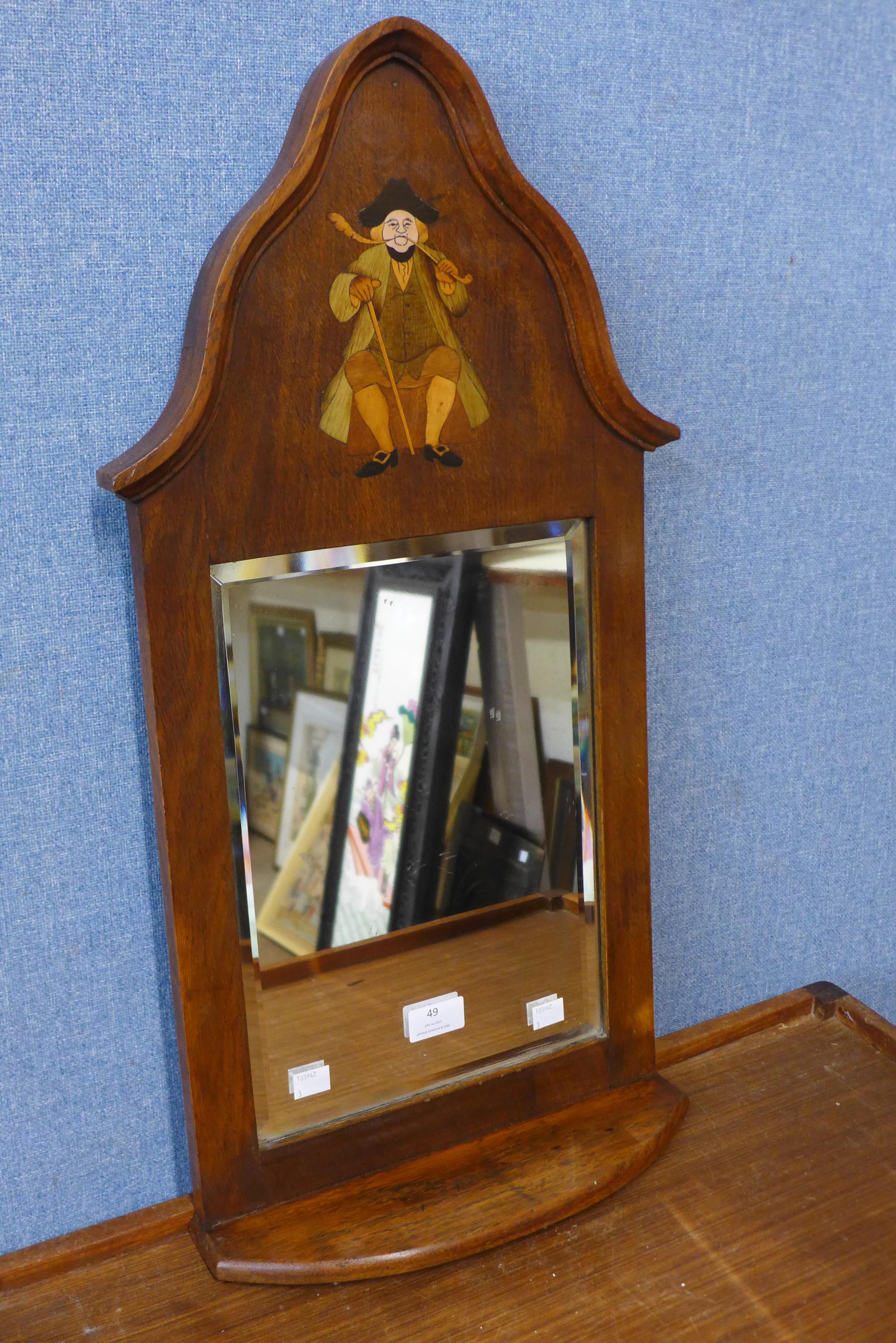 An Arts and Crafts inlaid oak hall mirror, attributed to Liberty & Co., 69cms h