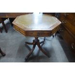 A mahogany and green leather topped octagonal drum shaped occasional table