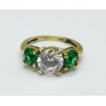 A silver gilt, green and white stone trilogy ring, J