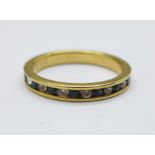 A silver gilt, blue and white stone eternity ring, Q