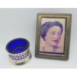 A silver salt with blue glass liner, 28g and a silver fronted rectangular photograph frame, 8x10.5cm