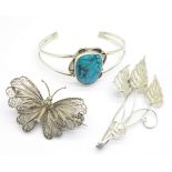 A silver and turquoise mounted bangle and two filigree brooches including a butterfly