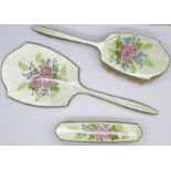 A three piece silver and enamel brush and mirror set, some enamel a/f