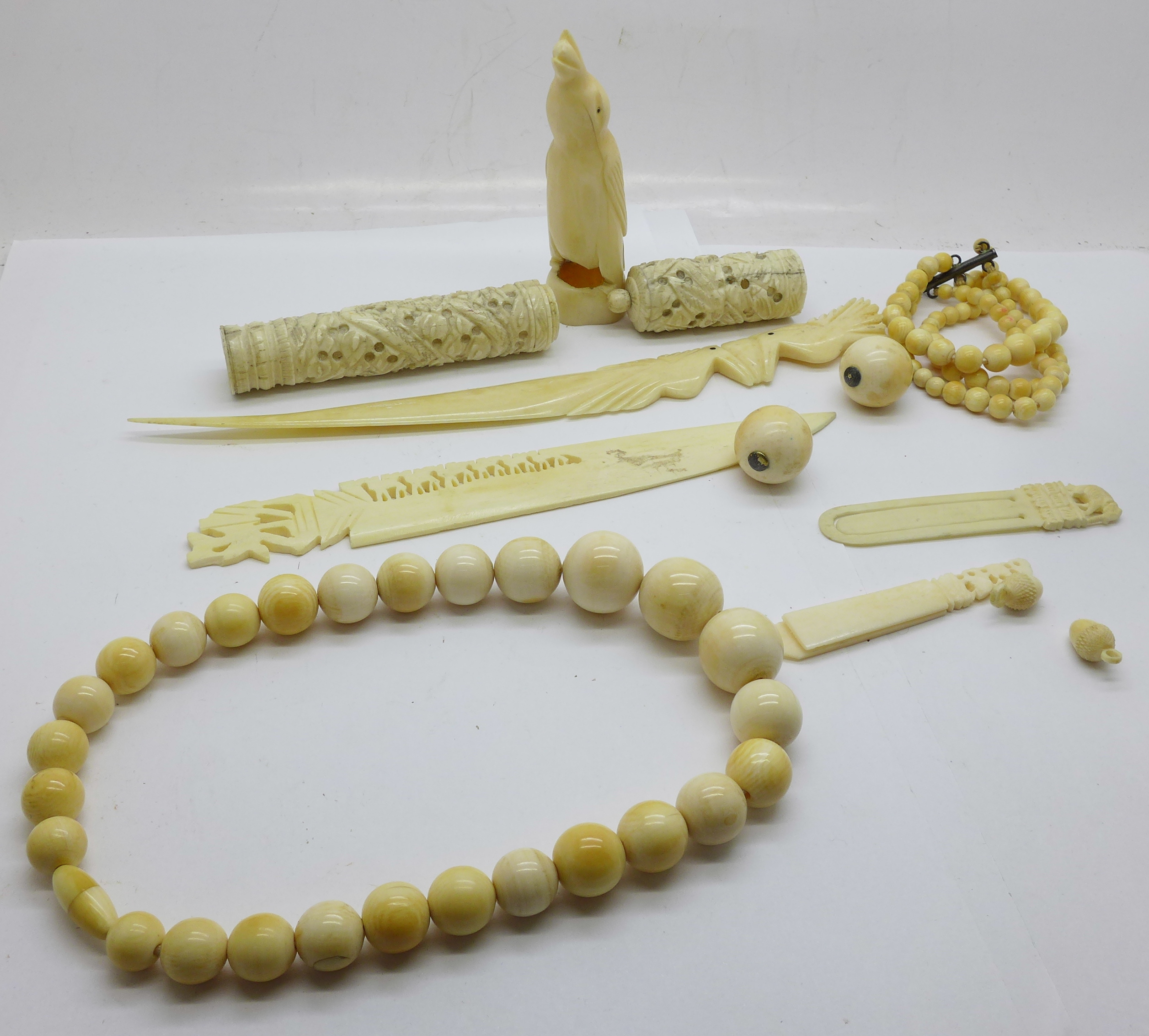 Antique ivory jewellery including two bead necklaces, carved penguin, needle case (a/f), and two