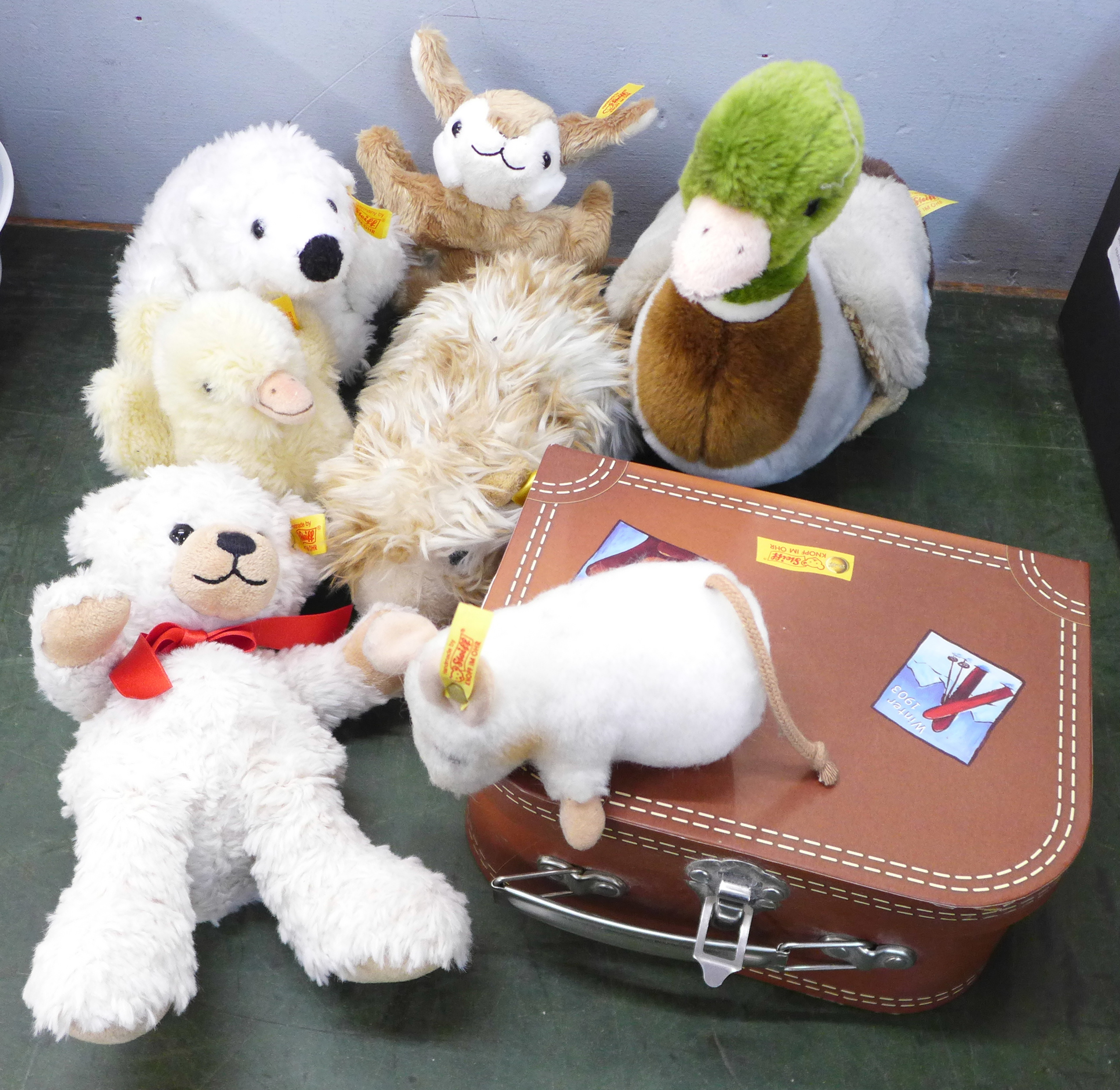 Seven Steiff soft toys and a Steiff case