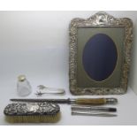 Silver items; photograph frame, silver backed brush, a fountain pen, sugar bows, pepper and an