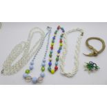 A snake bangle, four vintage bead necklaces and a brooch