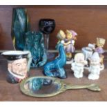 Two coloured glass vases, a Royal Doulton Henry VIII character jug, two Hummel figures, (Book keeper