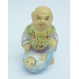 A small hand painted porcelain figure of a father and child, impressed 4916 to the base, 42mm