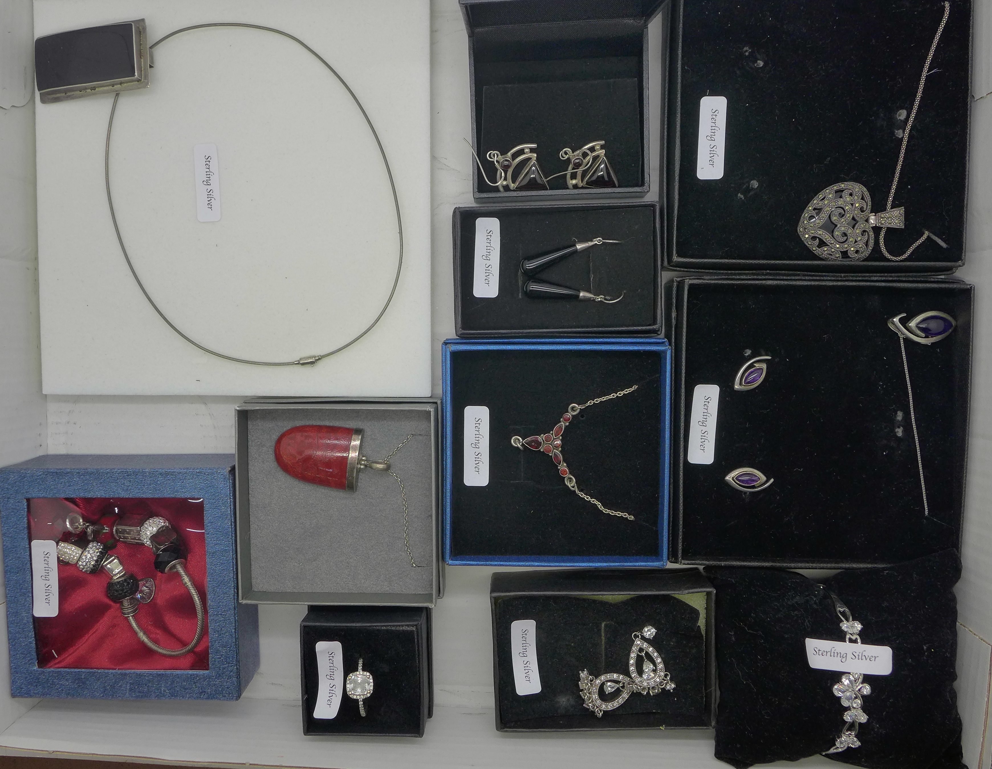 A collection of silver necklaces, earrings, charm bracelet, ring, etc., boxed